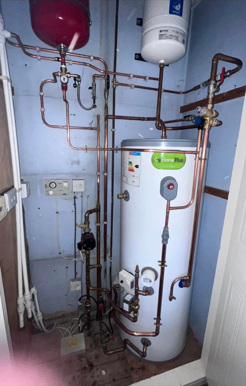 The same cupboard after the work, with new pipework